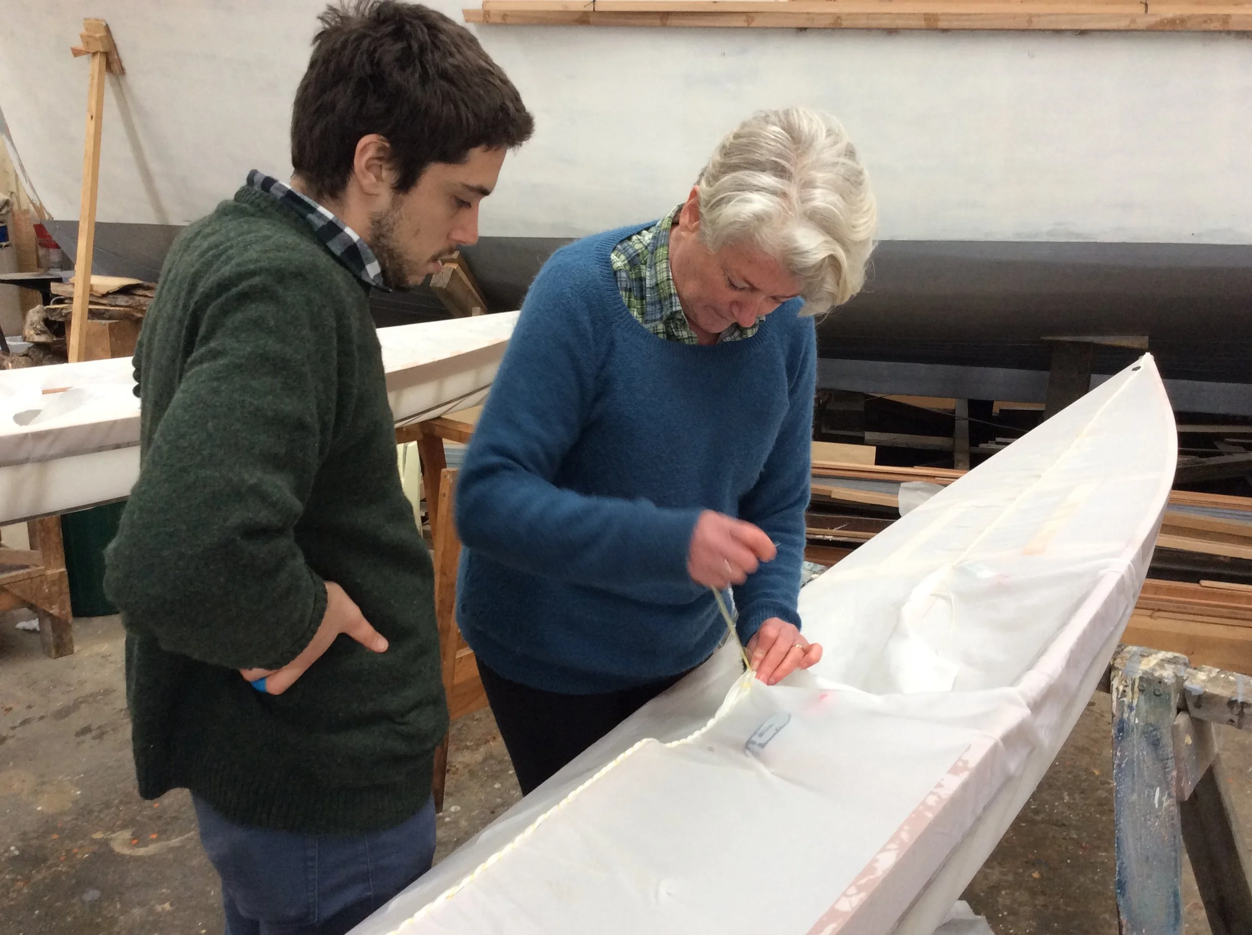 Joe and Heather sewing their skin onto the frame
