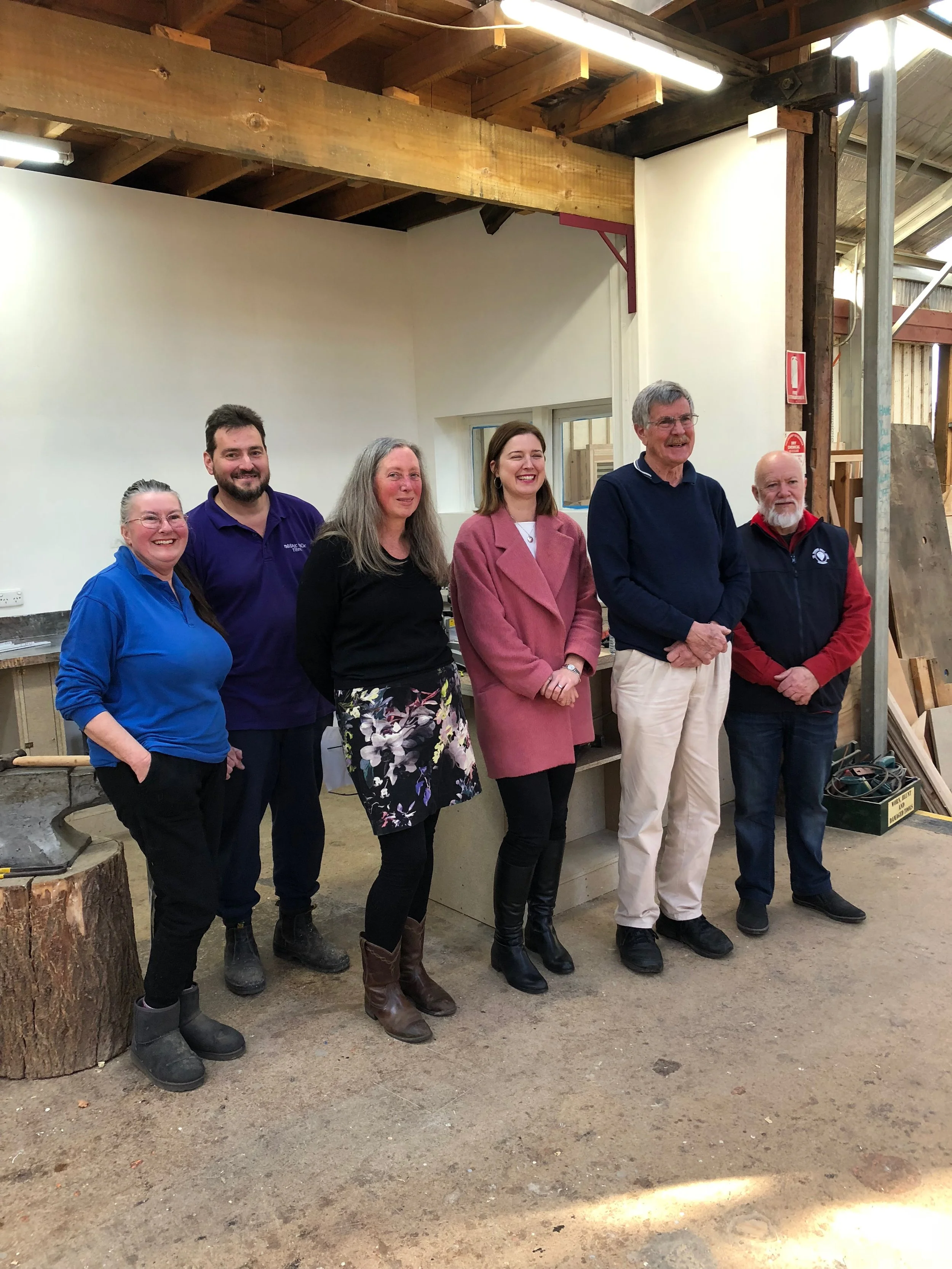 Christina Kent, Francis Shepherd, Anne Holst, Julie Collins, Alan Cato and Graham Rankin in front of the metal work area that is having a facelift.
