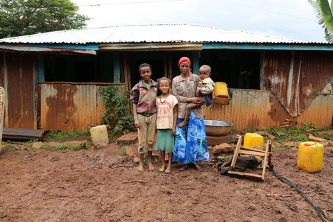 Chaltu and part of her family. Gobena, 12, Mihiretie, 10 and Yohannes, 3. Image by WaterAid/Behailu Shiferaw.