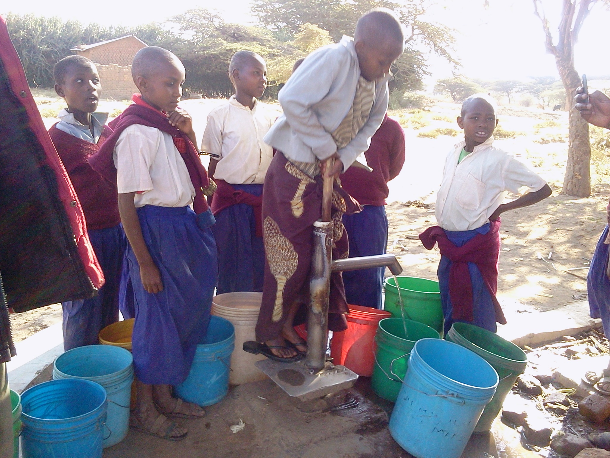 Children using the new water pump, WaterAid