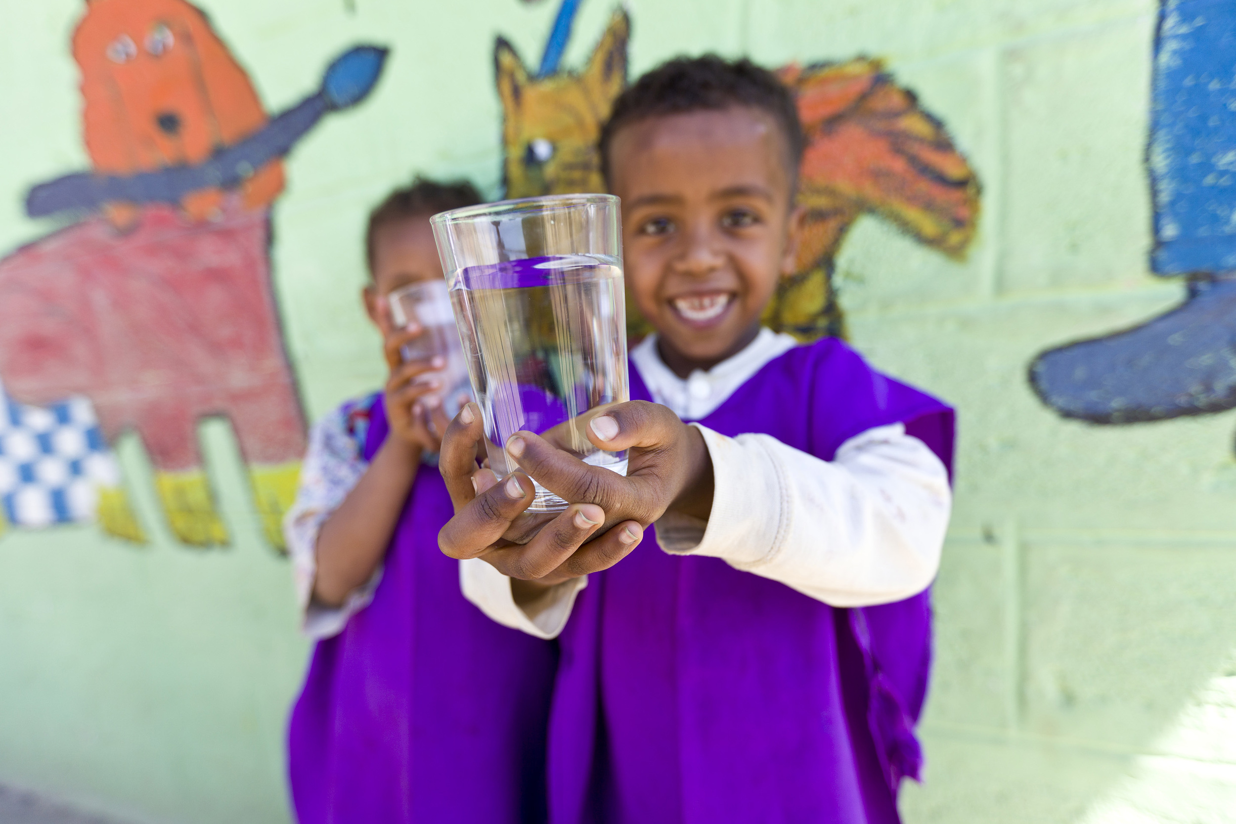 children in an orphanage enjoying filtered drinking water, splash