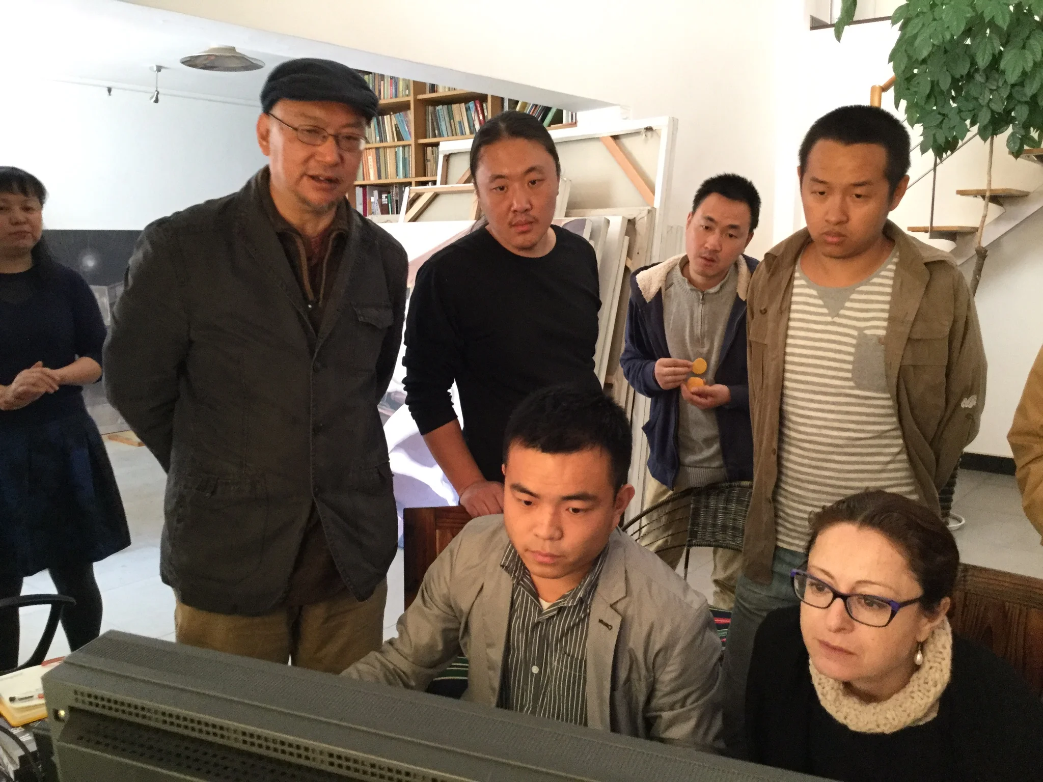  In Wu Jun's studio,&nbsp;checking the quality of the professional photographs of his works. 