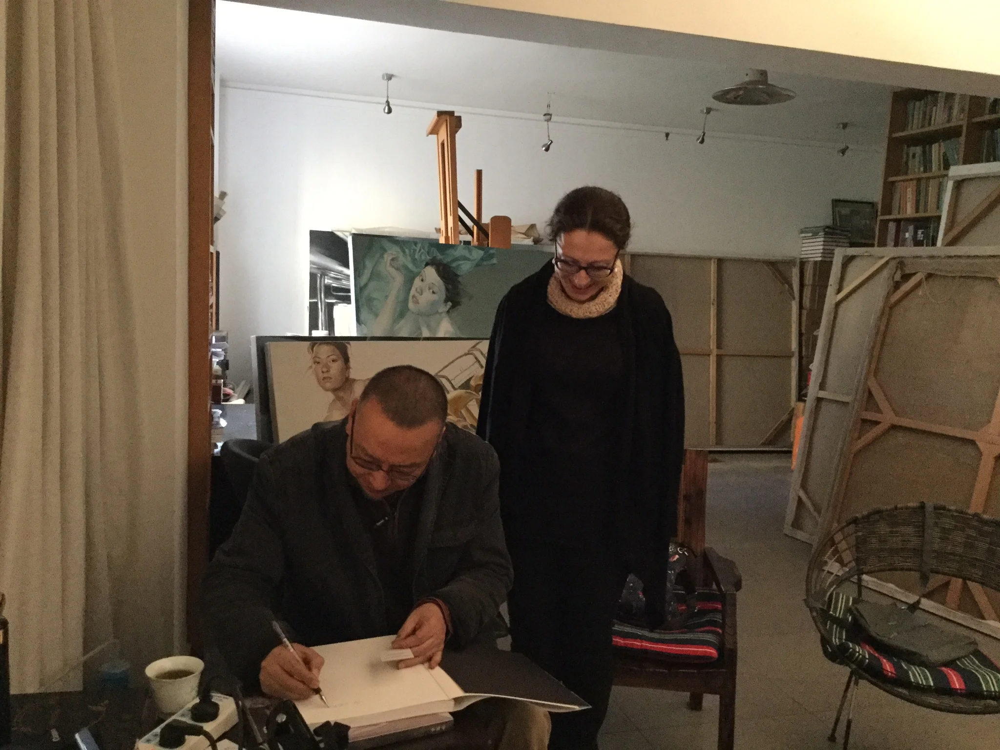  Wu Jun signing a copy of his catalogue of works. 