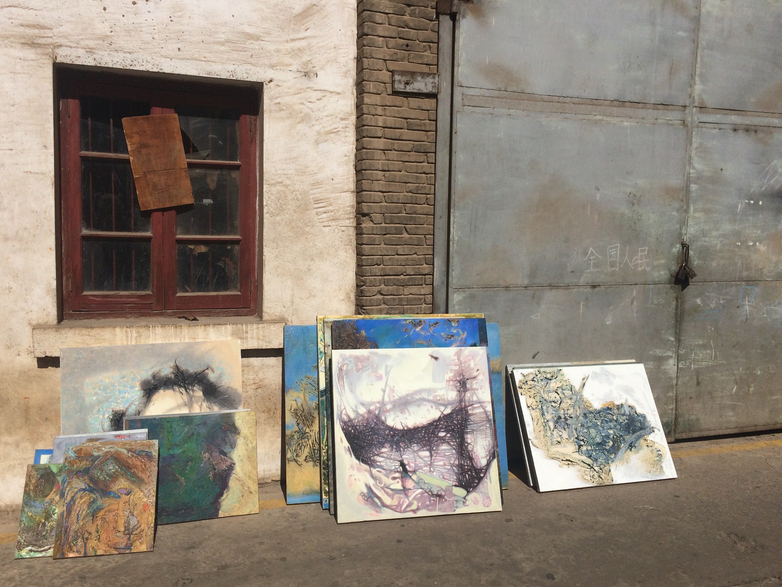 A picturesque lineup, complete with Chinese graffiti on the metal garage door.