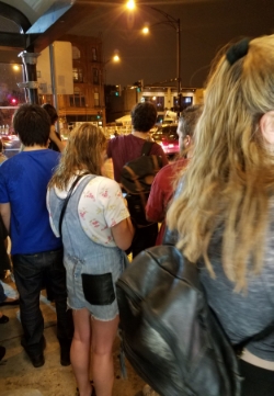 Our guy in middle of picture in maroon shirt with backpack.