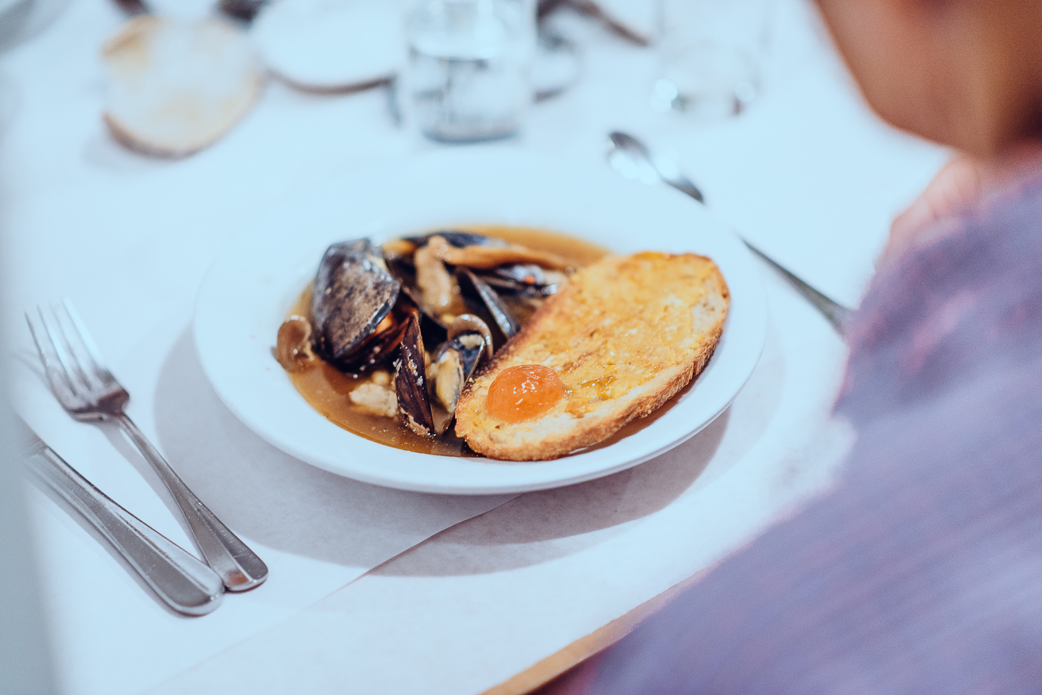 Jacked up dashi with mussels, blue oyster mushrooms, wakame, ocean toast, uni butter, and fermented shrimp spheres