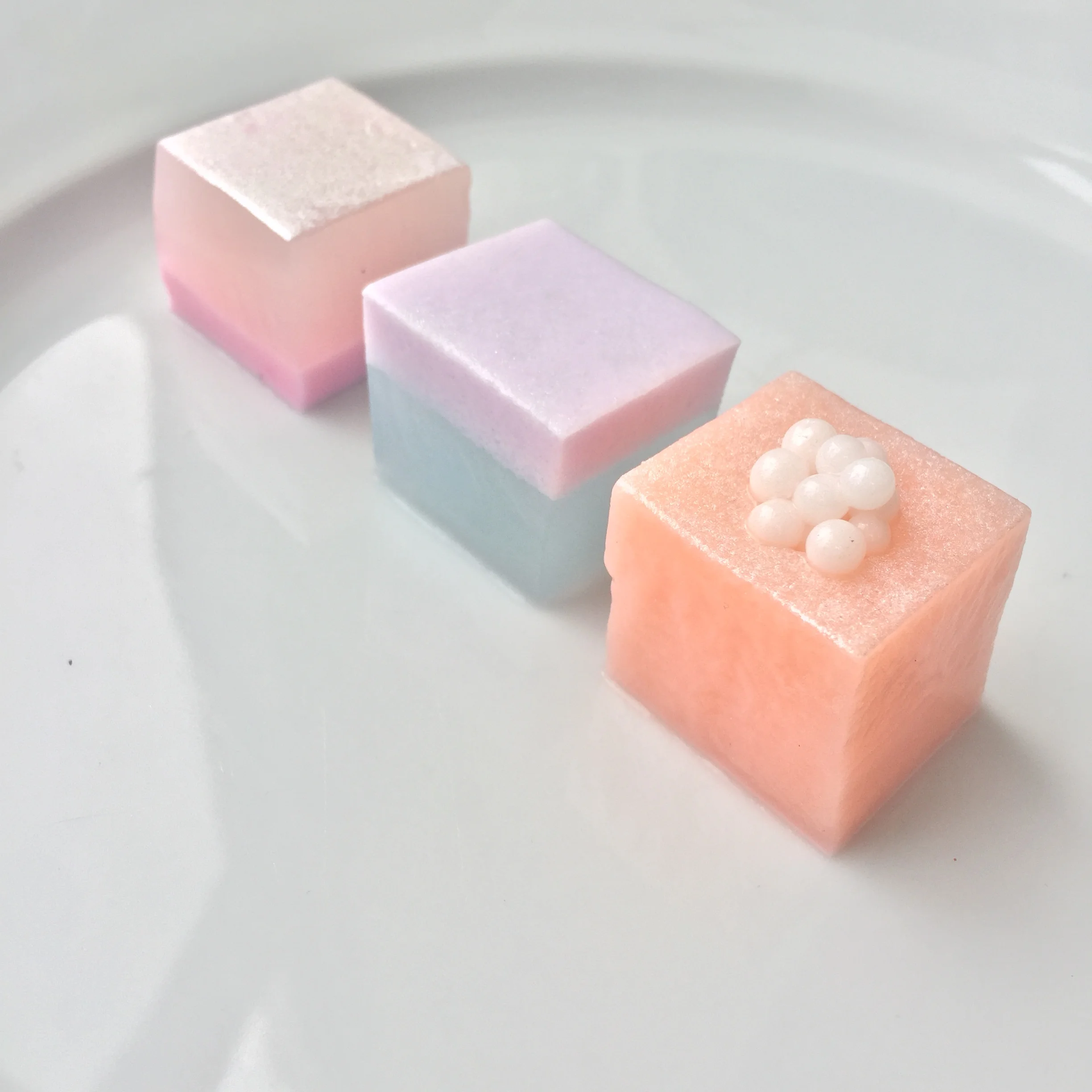  Cosmetics-inspired shimmery agar jelly squares in rose, blackberry, and grapefruit for Bobbi Brown event at Mansur Gavriel. 