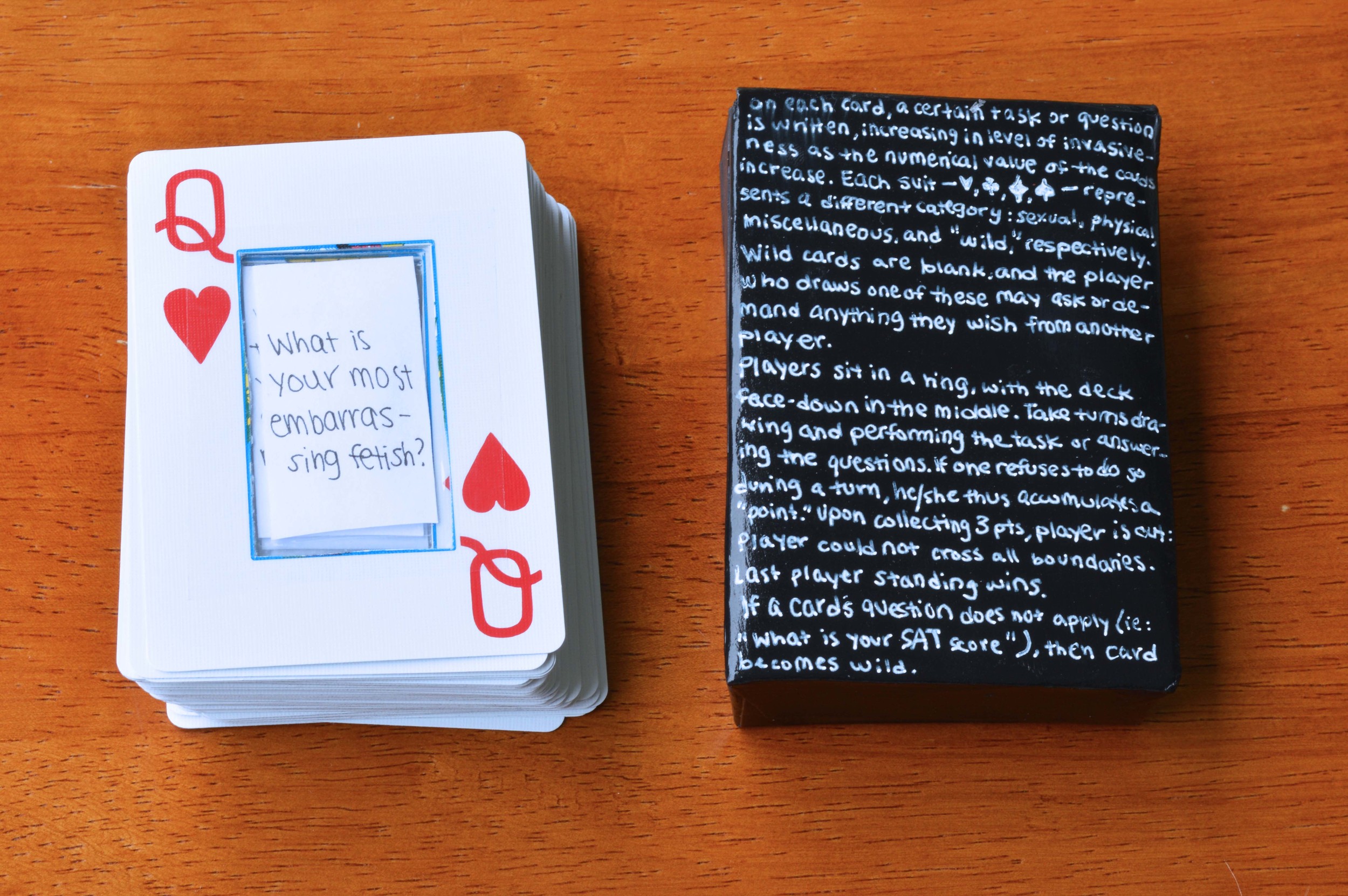 altered standard 52-card deck (paper inserts attached with scotch tape), back of handmade box