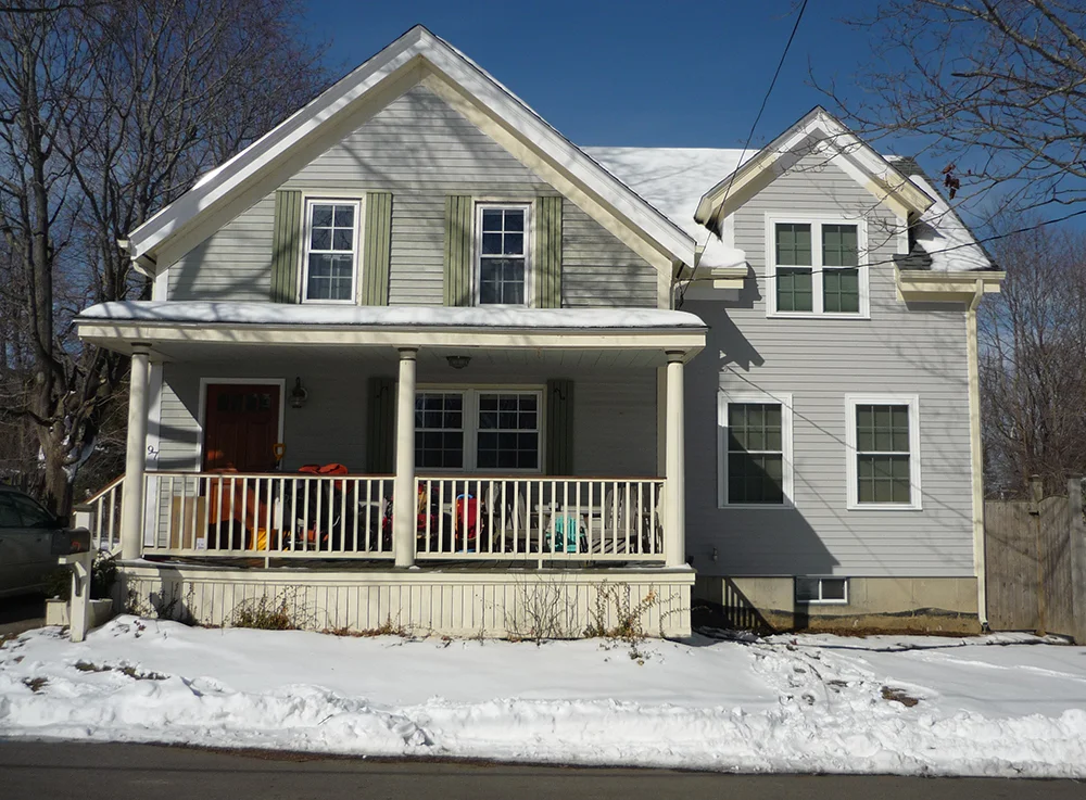  Front view with completed addition above and before addition was added below. 