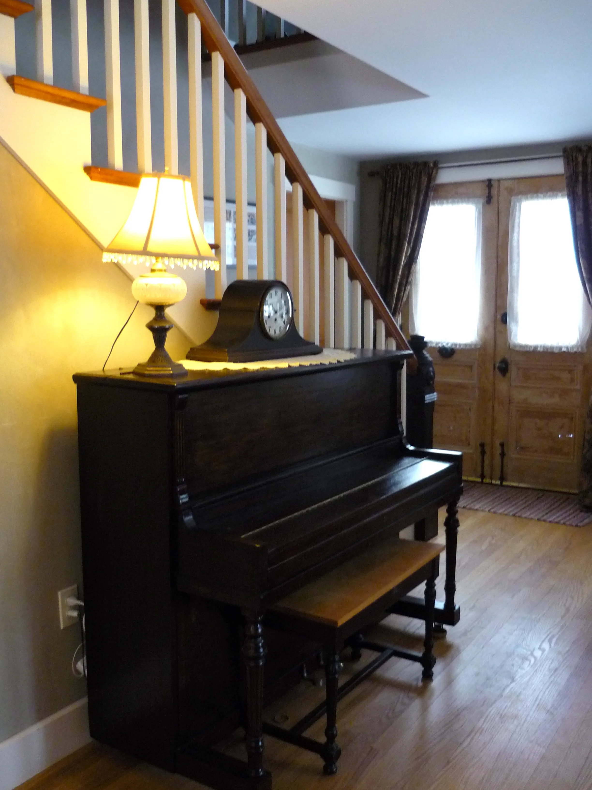  Incorporating salvaged materials — front doors and newel post above and slate fireplace surround below. 
