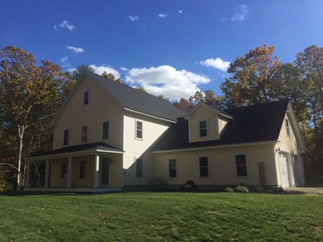 Front of completed home above and under construction below 