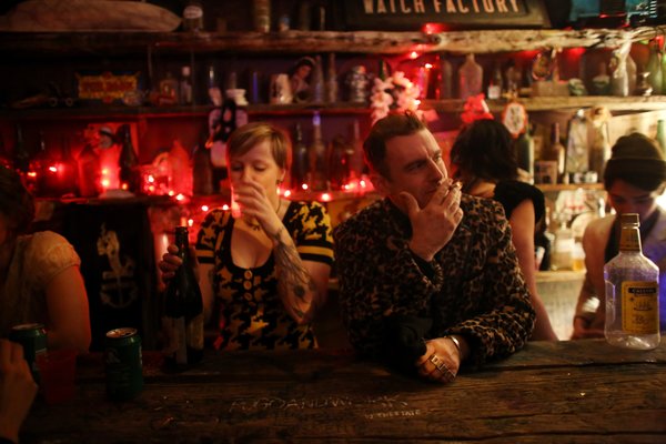 Duke Riley, right, enjoyed the last night's festivities at a speakeasy in Greenpoint, Brooklyn, on Saturday. KIRSTEN LUCE FOR THE NEW YORK TIMES