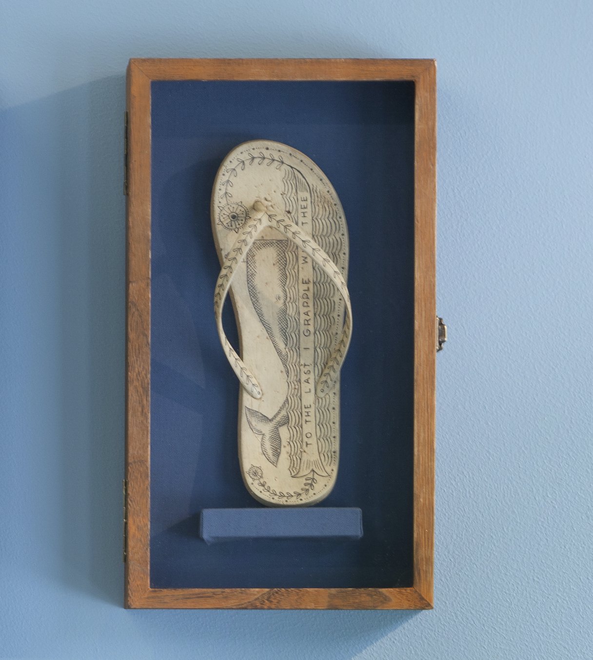   No. 227 of the Poly S. Tyrene Memorial Maritime Museum , 2020, Reclaimed ocean plastic, ink, wax in wood &amp; glass case, 14.88” x 8.5” x 2.75". Photo courtesy of Will Howcroft for Praise Shadows Art Gallery. 