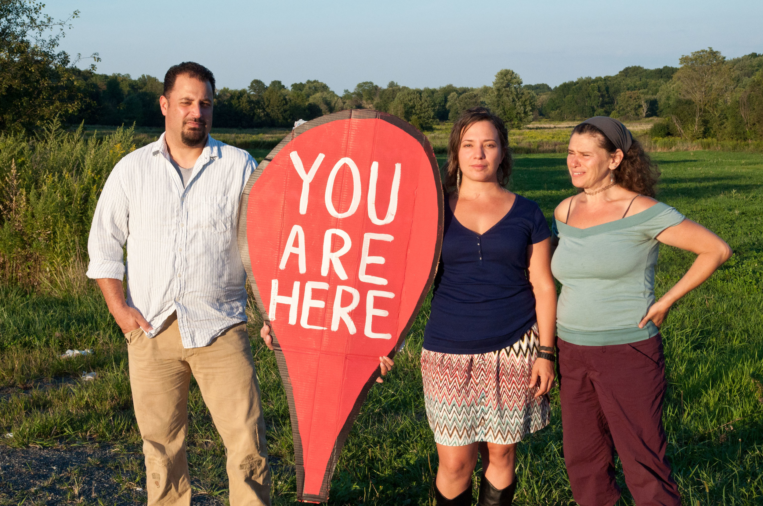 In 2014, Sane Energy Project (NYC) and community organizers across the state collaborated on the first comprehensive, interactive map of gas infrastructure and resistance in NY, the You Are Here project (YAH). Canalos was a contributor to the map and helped shape informative talks given in NY and regionally. In 2014, You Are Here was presented at the People's Climate March in NYC. Pictured here is Minisink resident Doug Burd, Asha Canalos, and local activist Melanie Gold, at the proposed site of the CPV Valley fracked gas power plant in Wawayanda, NY.