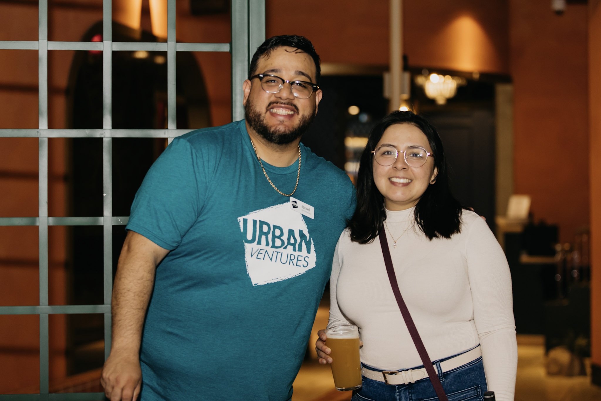 Two people smiling. One has an Urban Ventures shirt on.