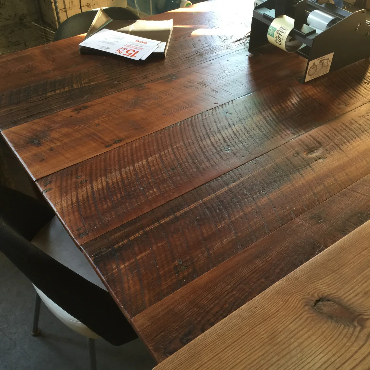 To accent their attention to the journey of their beans, we provided this café table, made of reclaimed heart pine boards we acquired through an extensive deconstruction of the One West Victory building, which used to be an old ice factory. The saw edge markings and old distress is still visible. 