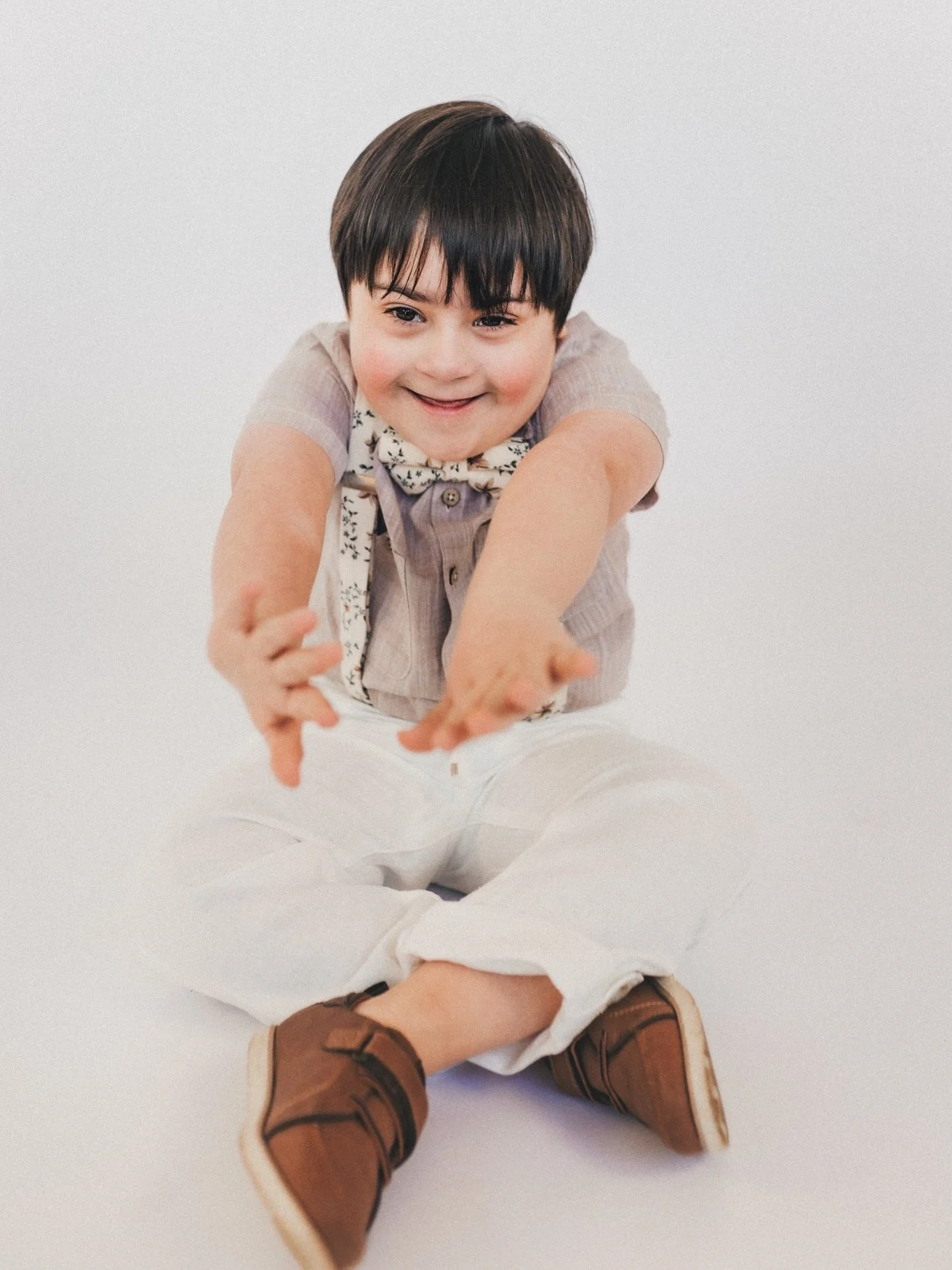 Happy World Down Syndrome Day to this HANDSOME little stinker 💙💛 You had zero interest in sitting on my cute wooden stool and went from tears to that irresistible grin the second we put on Teddy Swims. Jackson, we love you so&hellip;even though you