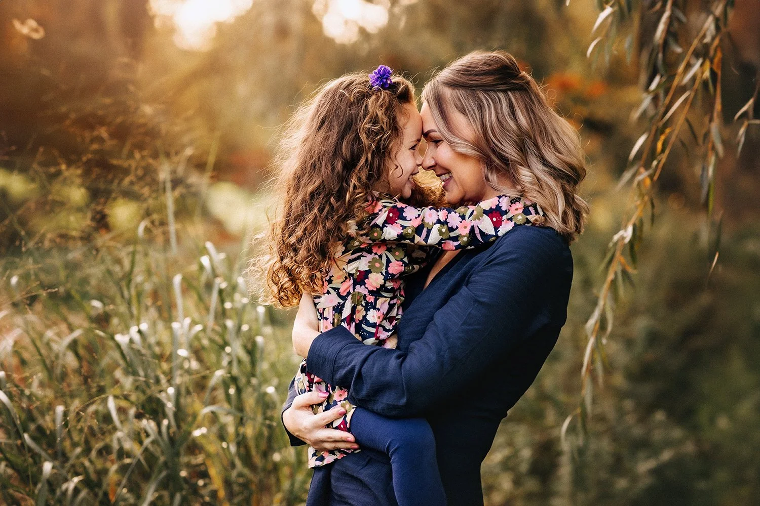 Mother and child laughing during outdoor family photo session