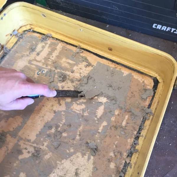 Scrape scrape scrape. Removing all the old paperboard backing.