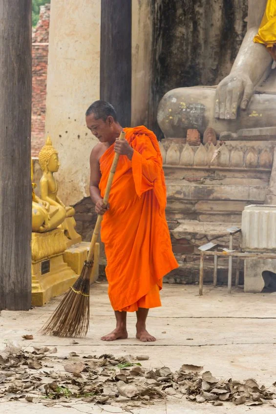 A buddhist monk sweeping