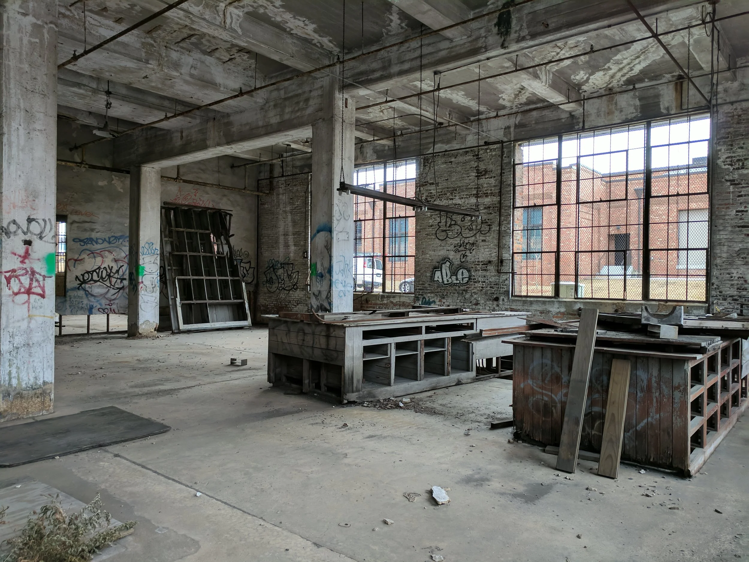 Interior photograph of workshop space that existed previously within the Central of Georgia Railway building. When designing a proposal for a revitalization of this space, it was important to our team to give homage to the history of the building and preserve the legacy that was created in this historic building.