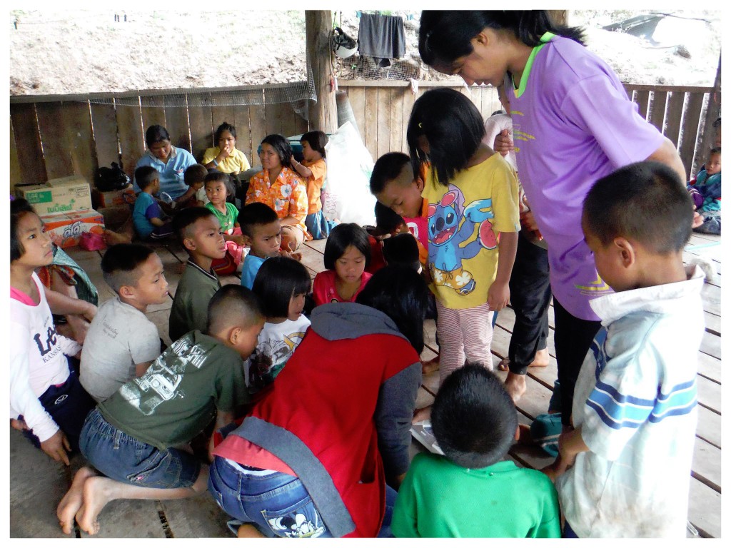 The children look on as each child is weighed and measured.