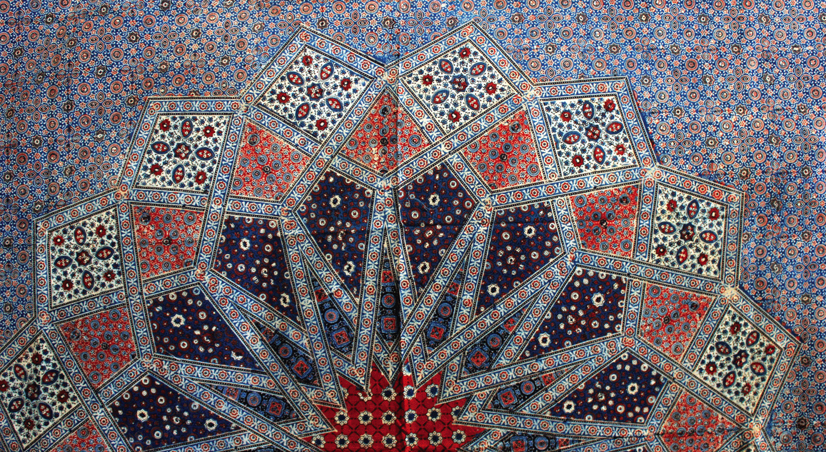 A bedspread's central pattern showing traditional Ajrakh motifs combined in a new way