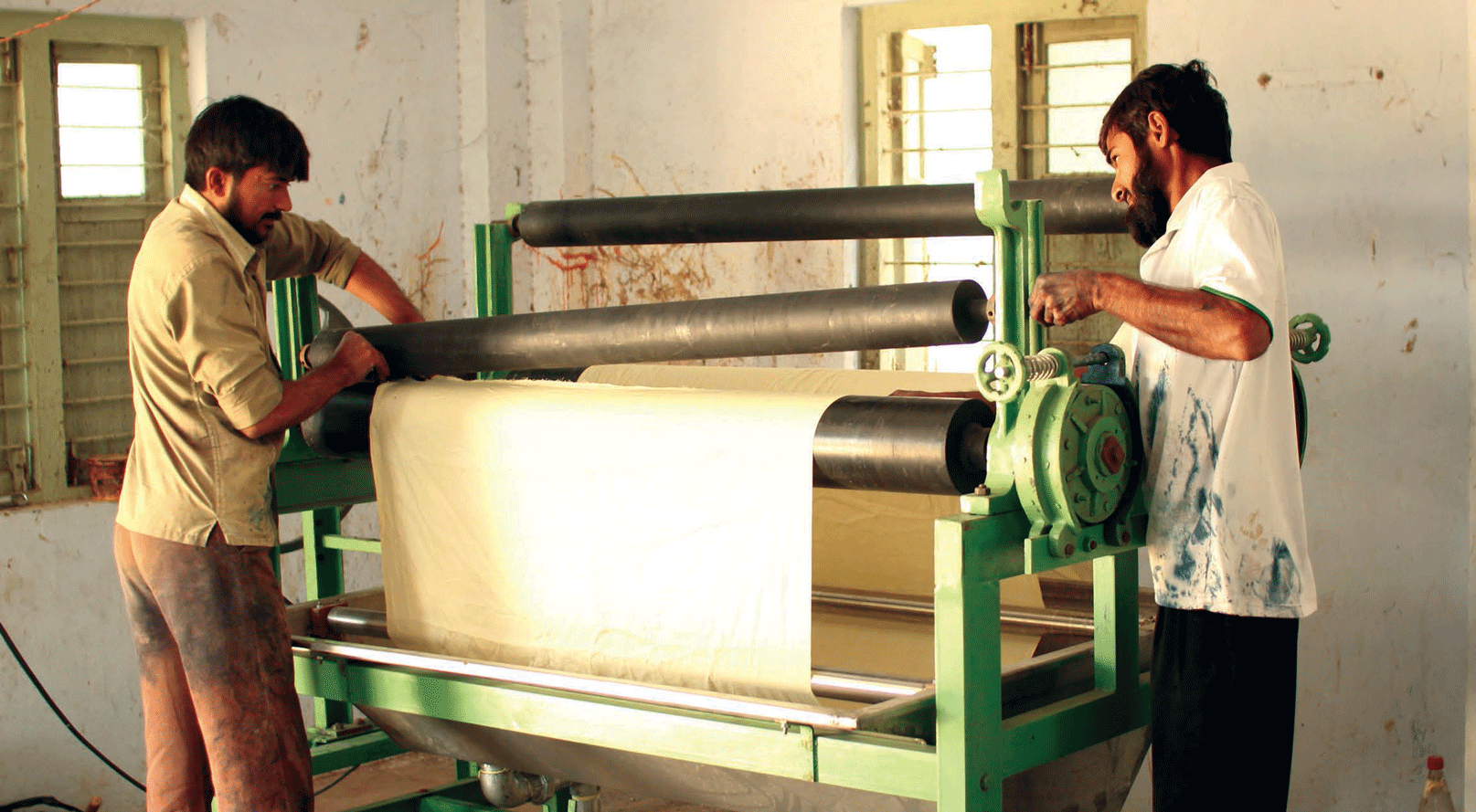Block printers from Ajrakhpur exploring the use of a machine to treat the fabric with Harde , a practice usually done manually