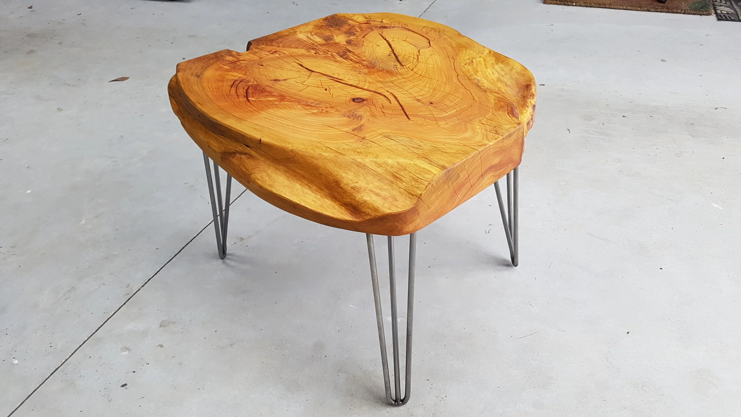600 x 600mm Macrocarpa on three pin legs, sold for $480