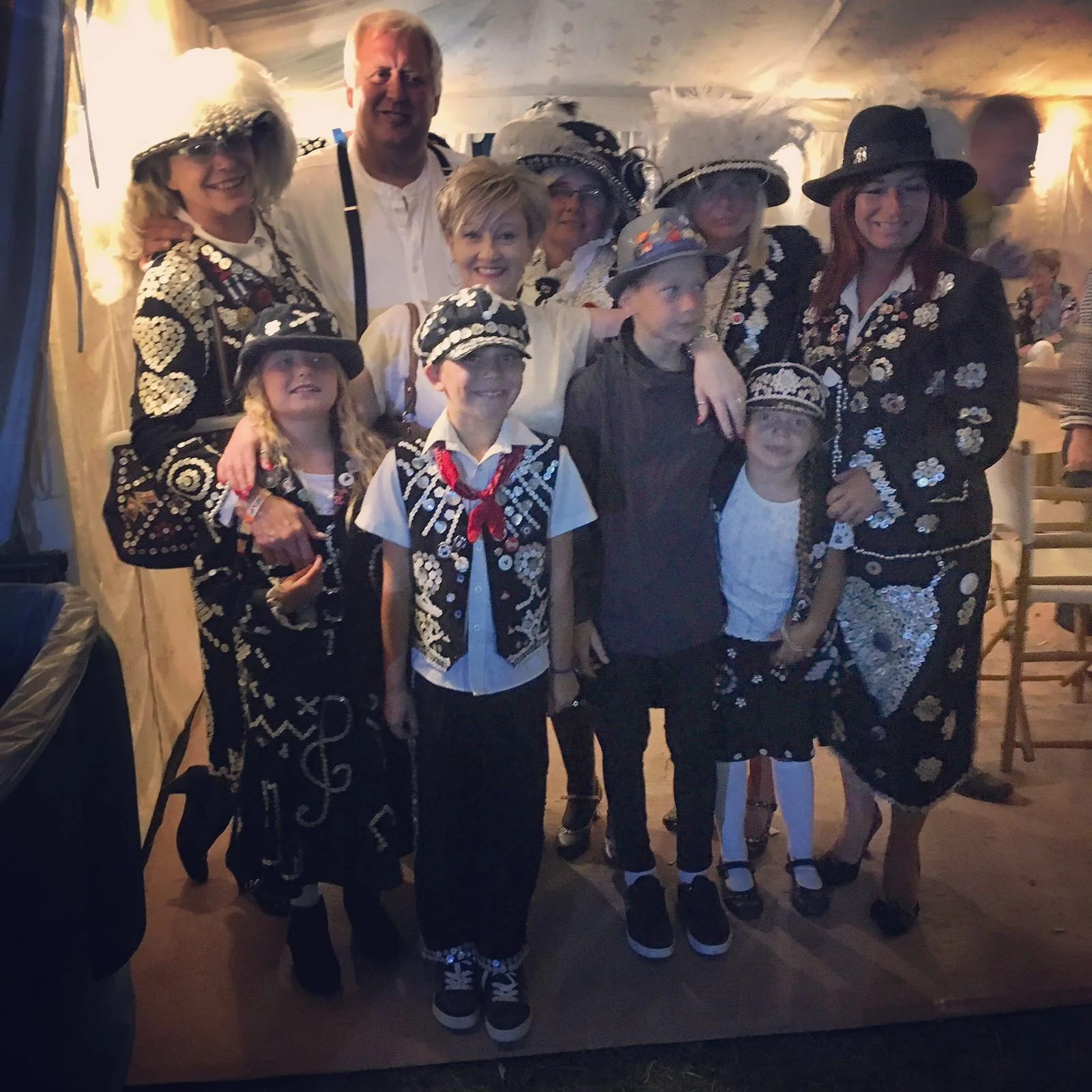 Group shot left to right back row Diane Gould, Pearlyking Jim, Pearly Queen Michelle, Pearly Queen Sherida, Pearly princess Karan. Front row LtoR Pearly Princess Lillie Bliss, Pearly Prince Cain, Pearly photographer Devon and Pearly princess Trinity. The lovely lady in the centre is the landlady of the Dublin Castle Samantha.