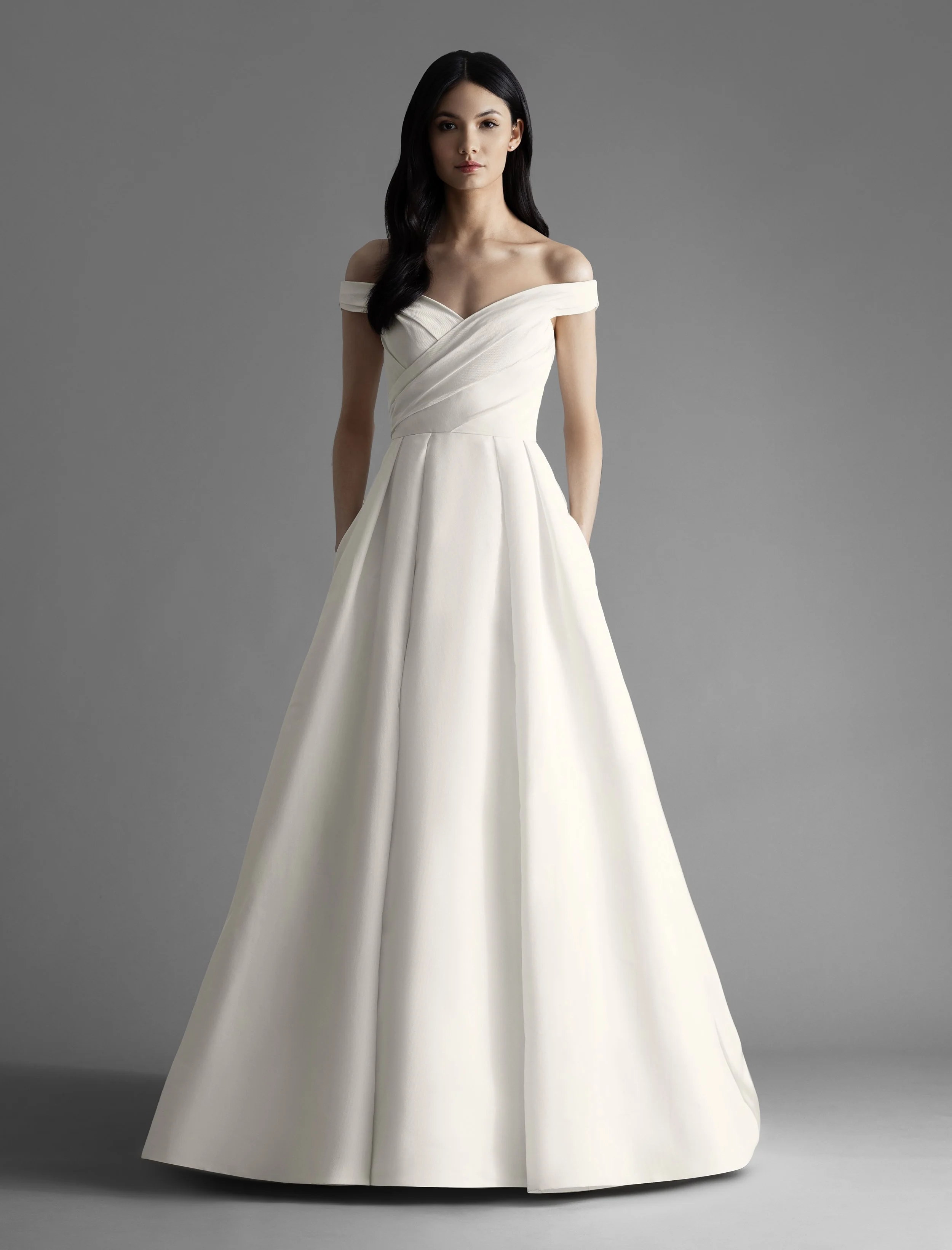 Style 4900 Ava Allison Webb bridal gown - Ivory silk faille pleated full A-line bridal gown with pockets and draped off the shoulder bodice, chapel train.jpeg