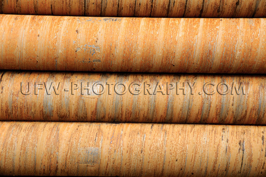 Drilling pipes detail rusty stacked circular pattern background 
