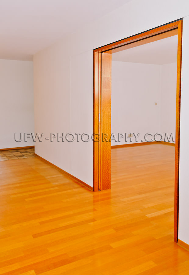 Empty apartment, dining and living rooms, wooden floor - Stock I