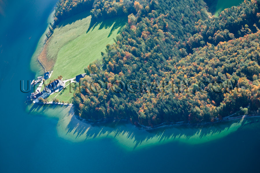 Deep blue lake island autumn forest spectacular aerial view Stoc