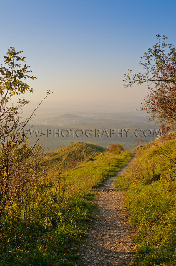 Hiking trail in the mountains, autumn scenic view, blue sky - St