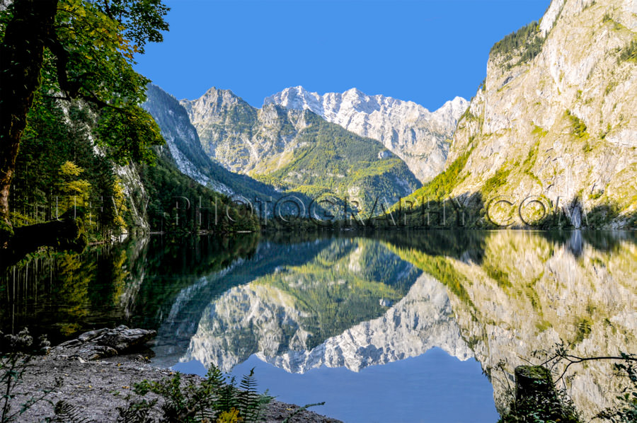 Mountain lake surrounded mountain-range dramatic reflection Stoc