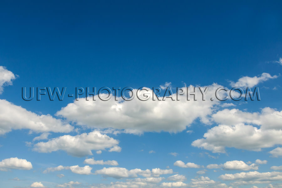 Blue summer sky, scattered clouds - Stock Image
