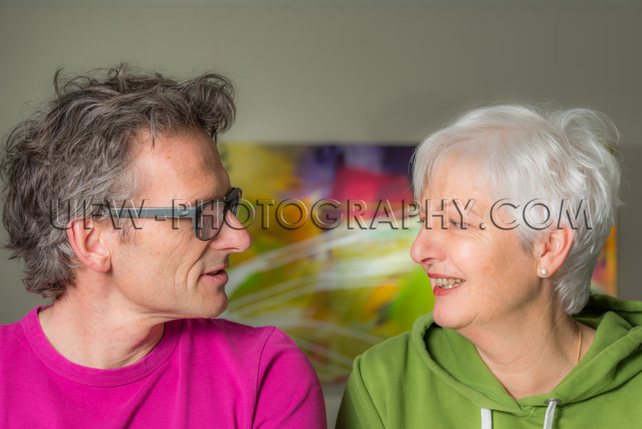 Happy smiling adult couple talking looking each other casual con