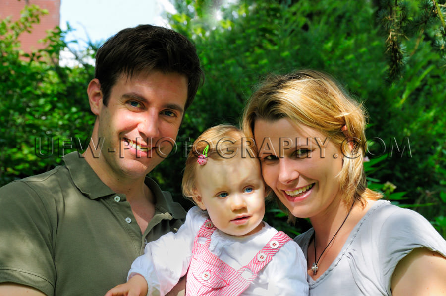 Happy young casual family standing garden dad mom girl toddler S