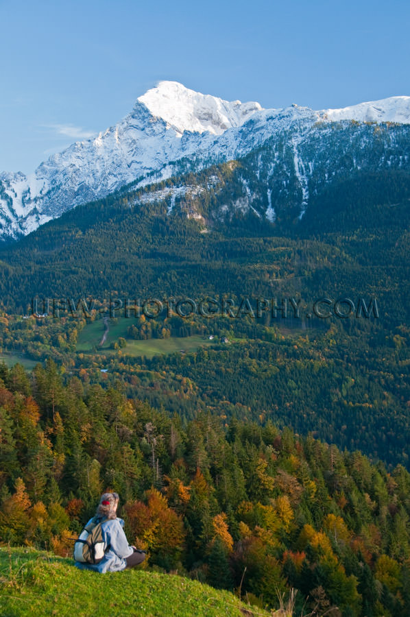 Hiker looking into a beautiful autumn colored mountain valley St