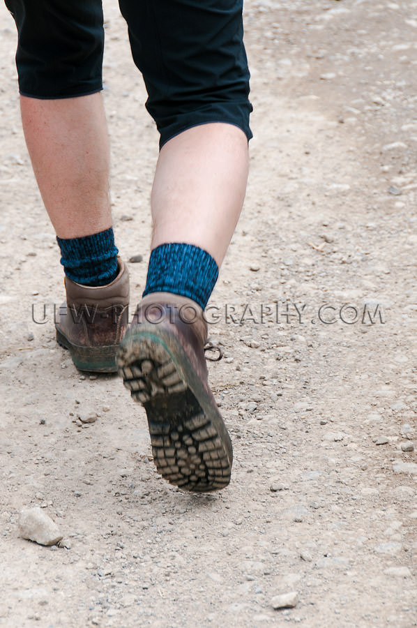 Hiking boots legs calves motion men trail walking Stock Image