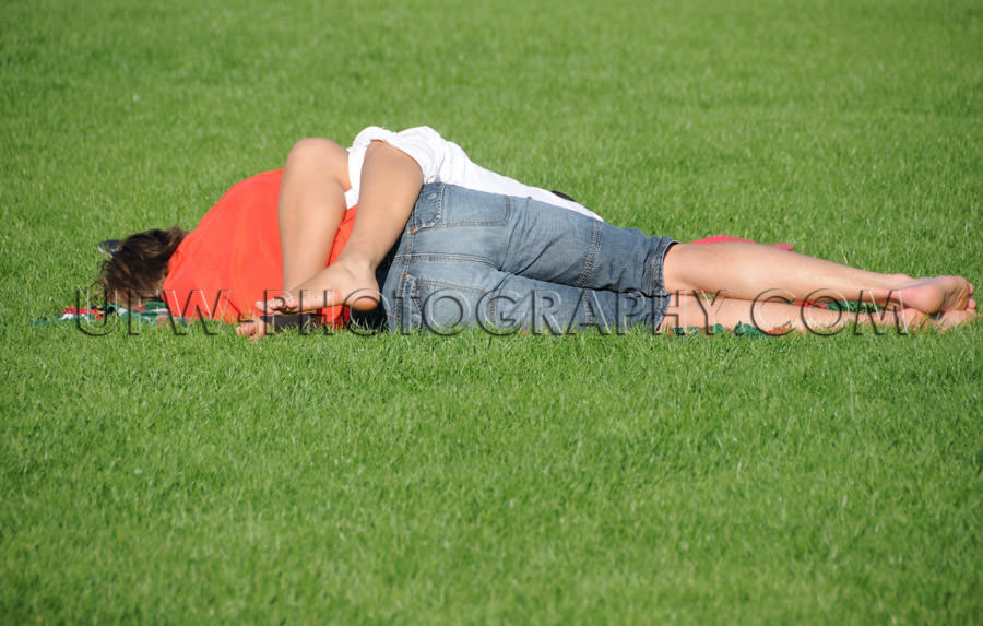 Lovely young couple lying green grass sleeping relaxing love tog