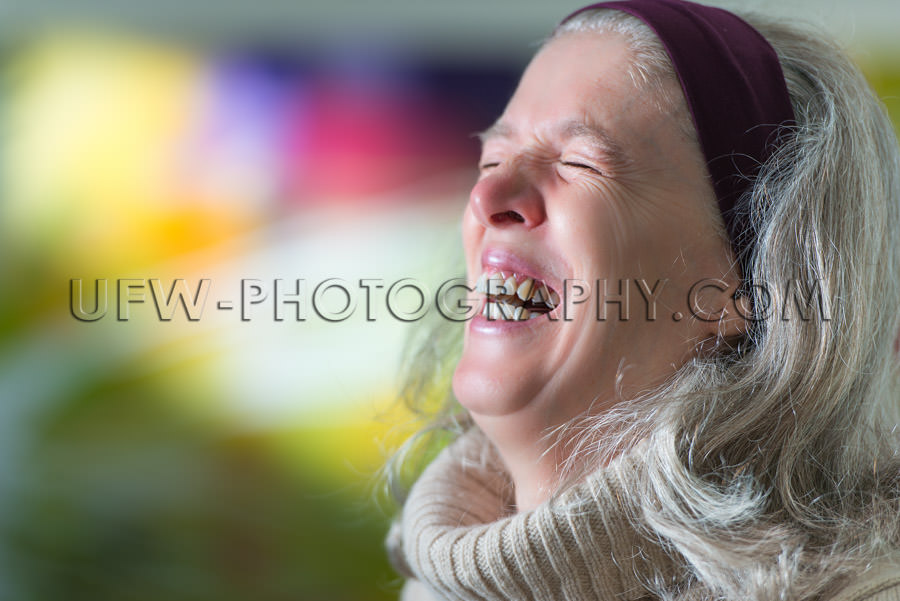 Mature woman laughing portrait head-wrap colorful background Sto