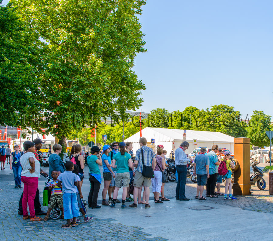 People stand in queue drinking fountain summer waiting thirsty S