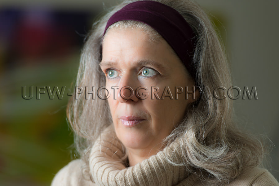 Portrait serious looking mature woman blurred background Stock I