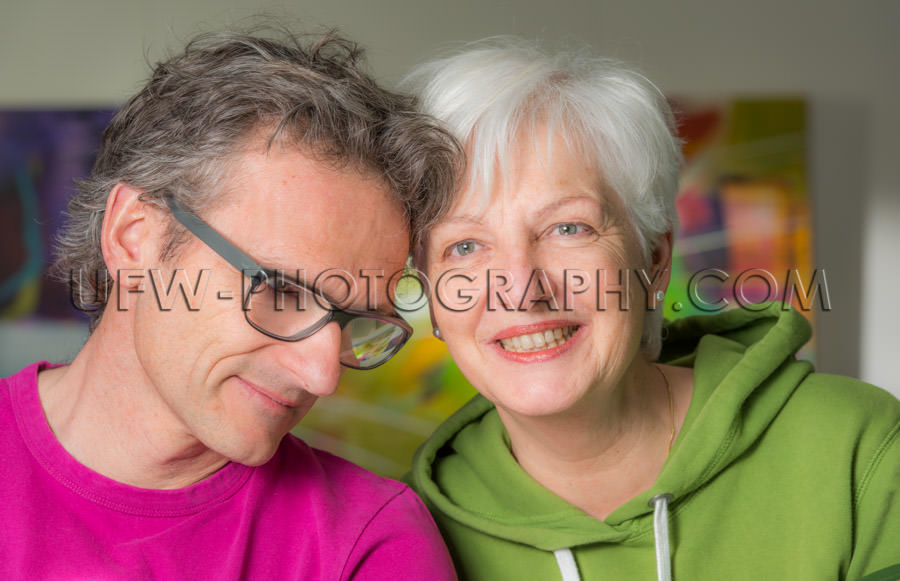 Serene smiling adult couple loving togetherness looking gray hai