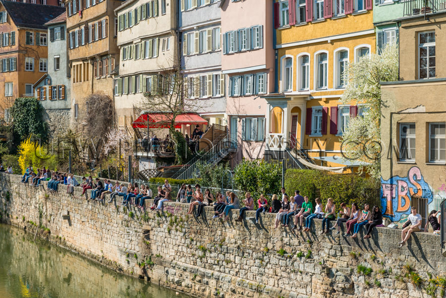 Students sitting on old wall river picturesque medieval universi