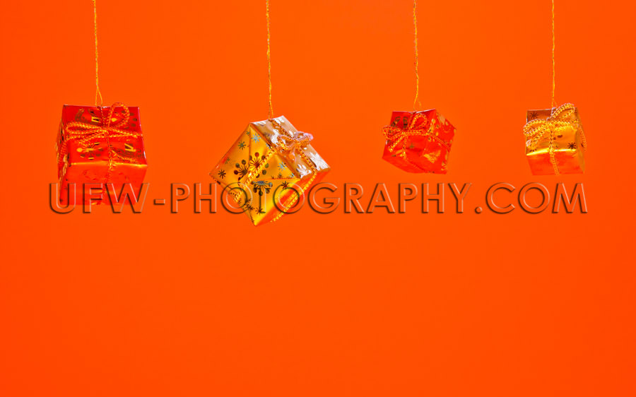 Hanging red and golden Christmas Gift Boxes Stock Image