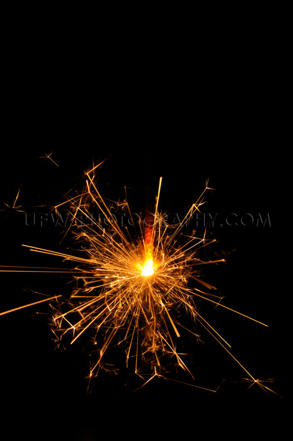Sparkling sparkler glowing red black background copy space Stock