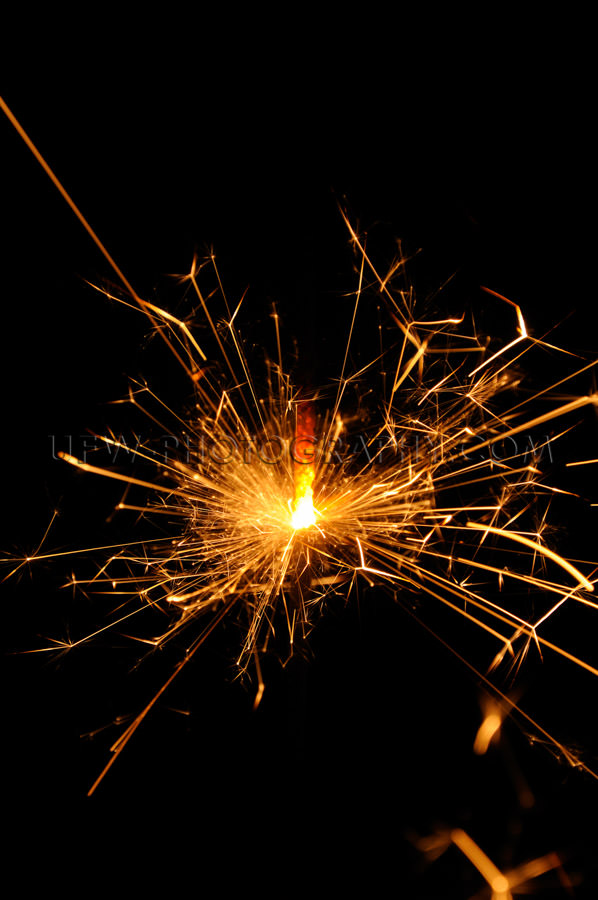 Flying red hot sparks glowing sparkler black copy space Stock Im